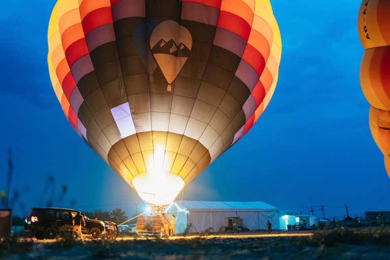 A hot air balloon being inflated at dawn in Dubai.