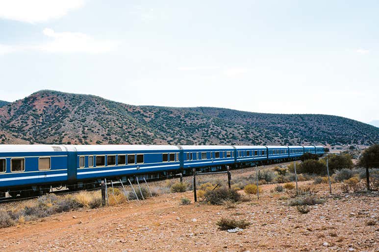 The Blue Train traveling through arid landscapes in South Africa.