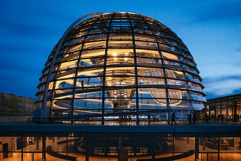 Visitors walking inside the glass dome of the Reichstag in Berlin.