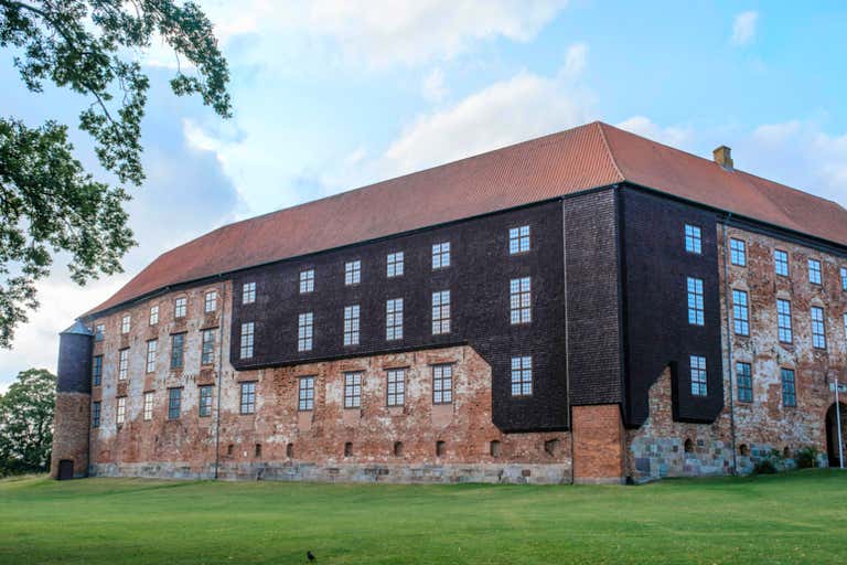 Imposing medieval Koldinghus Castle with distinctive brick facade and numerous windows, a must-see historical landmark in Denmar