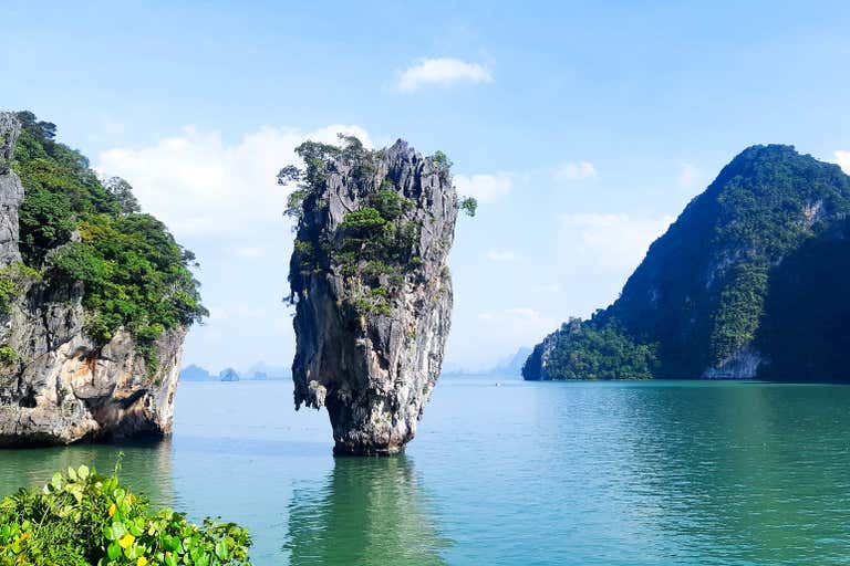 Khao Phing Kan Island's iconic limestone karst tower rises from emerald waters in Phang Nga Bay, a bucket list destination in Thailand