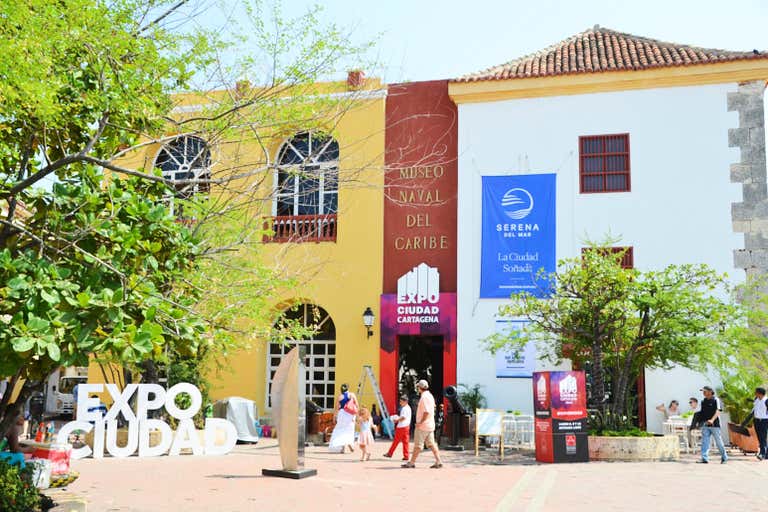 People walking outside the Museo Naval del Caribe in Cartagena.