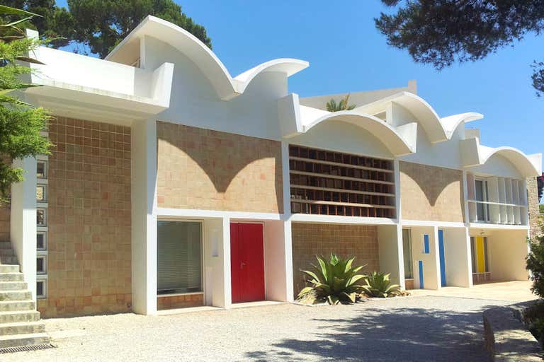 The modern Joan Miró Mallorca Foundation building has a wavy roof and colorful doors in Mallorca.