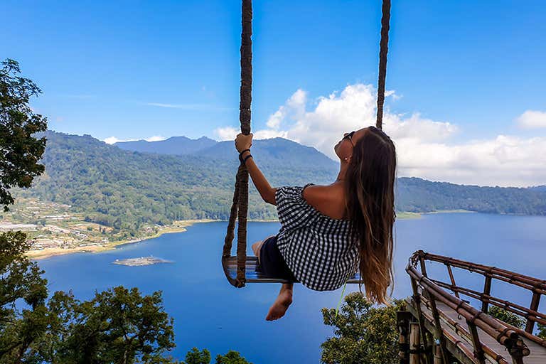 A person swinining on a Wanagiri Hidden Hills Swing