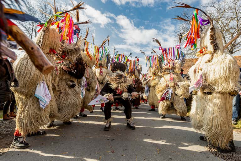 People wearing traditional costumes at Kurentovanje Festival in Ptuj, Slovenia.