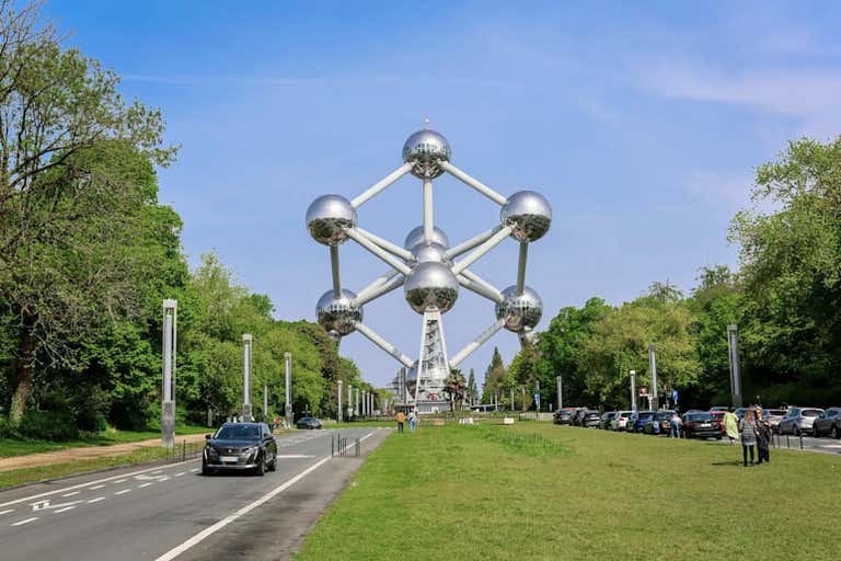 View of the Atomium in Brussels surrounded by greenery and a clear sky.