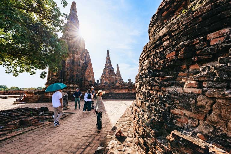 Visitors exploring ancient brick temples and prangs at Ayutthaya Historical Park, UNESCO World Heritage site