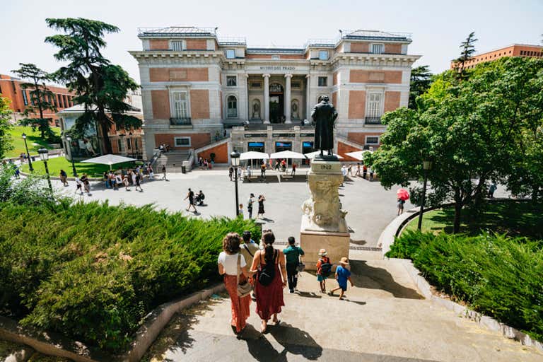 Pessoas caminhando em direção à entrada do Museo del Prado em Madri.