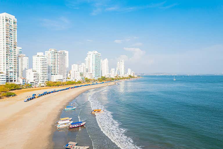 Aerial view of Cartagena's Bocagrande beach with skyscrapers and boats.