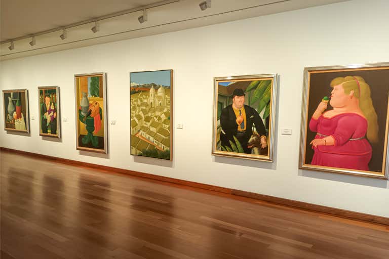 A gallery in Museo Botero featuring Fernando Botero’s iconic paintings of exaggerated proportions.