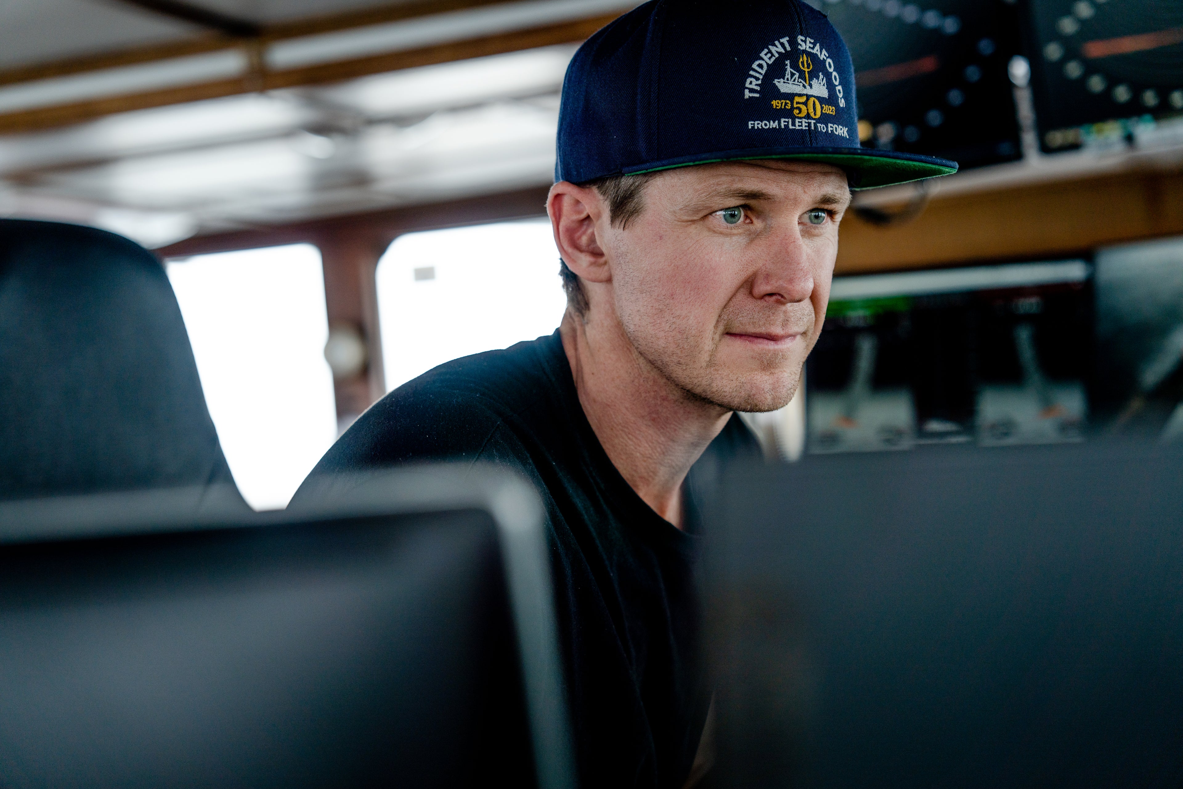 Captain Gus Molan in the wheelhouse of the F.V Northern Patriot. 