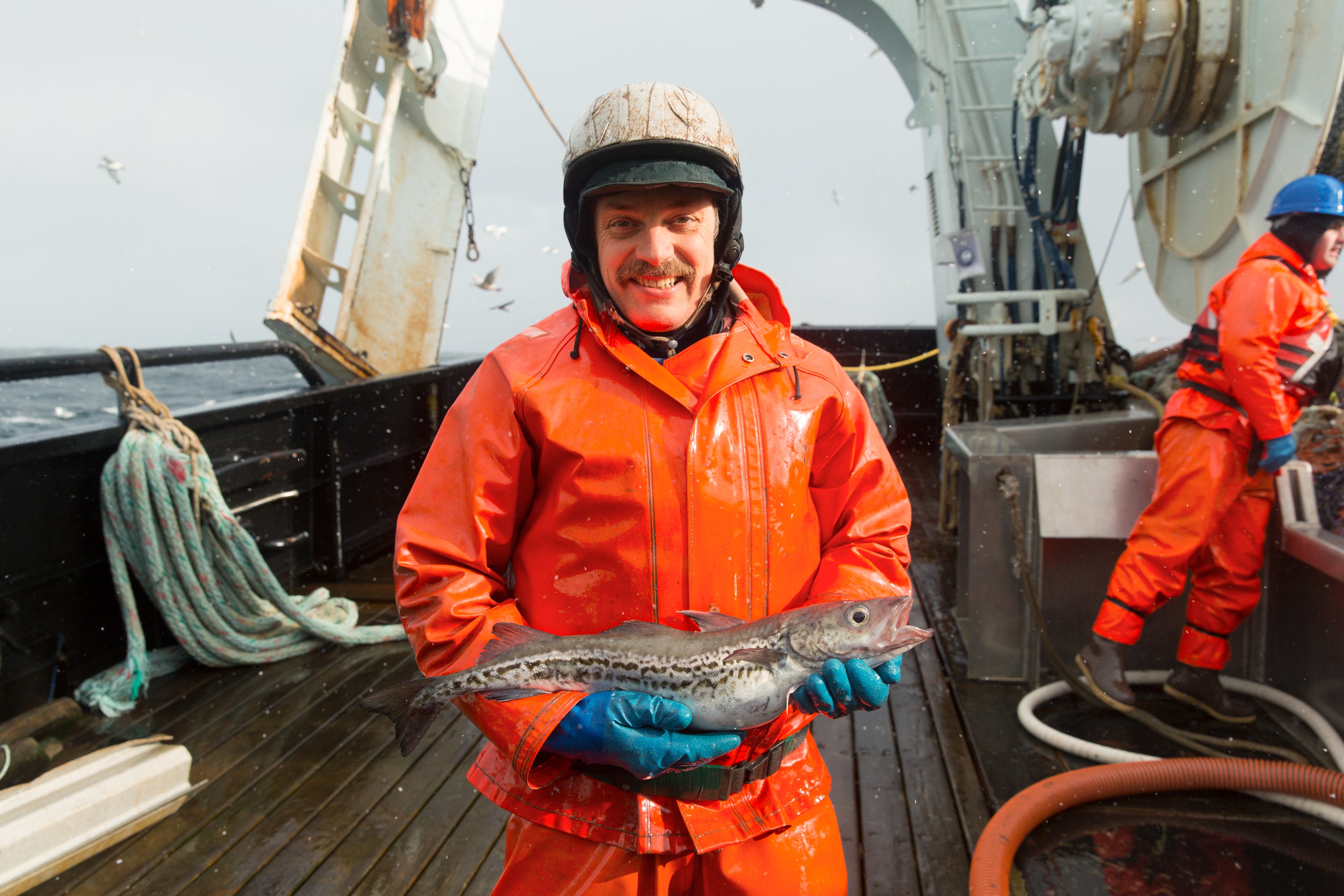 Fisherman holding Wild Alaska Pollock