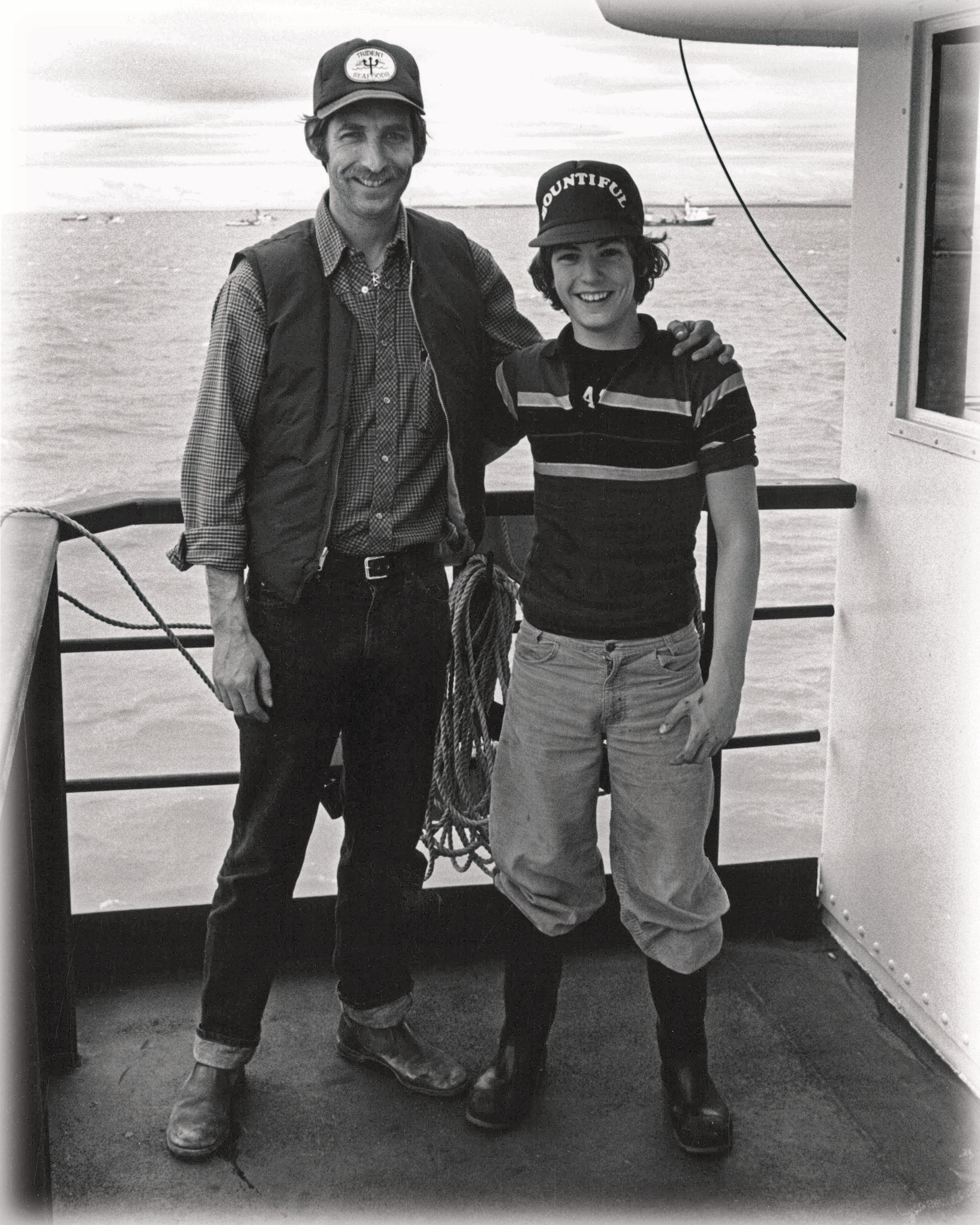 Chuck and Joe Bundrant standing together on a boat