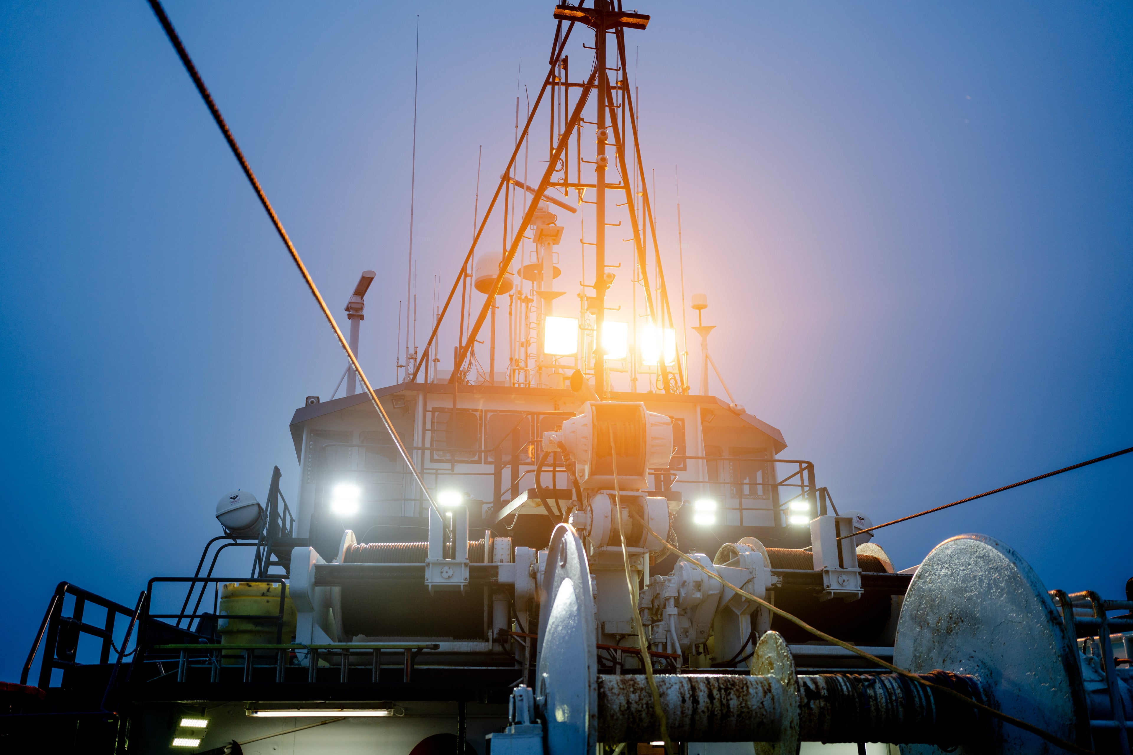 Sodium lights shine down on the deck of the F/V Northern Patriot, a trawl vessel fishing wild Alaska pollock in the Bering Sea