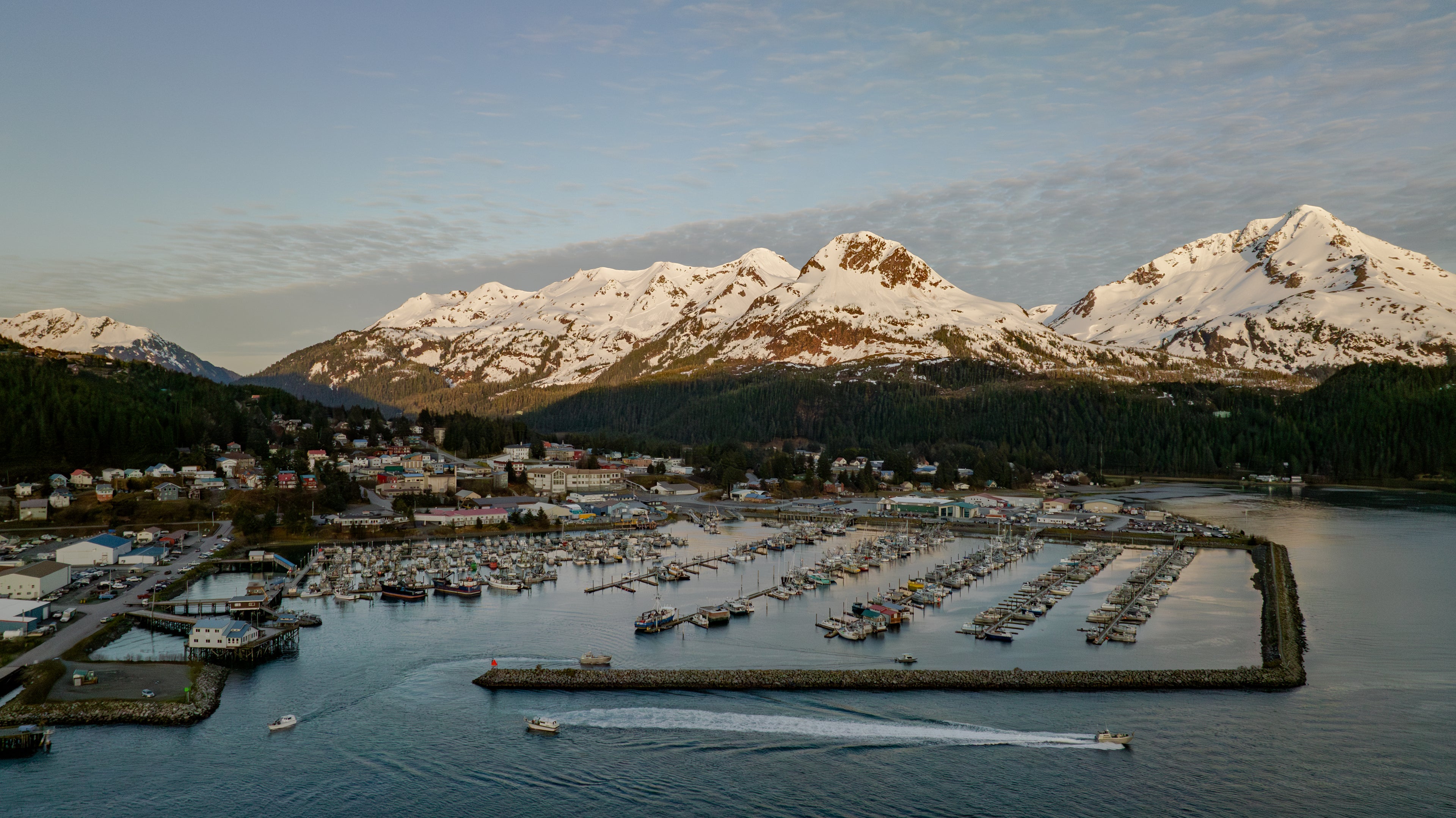 Picture of cordova, alaska from a distance with mountains in the background. 
