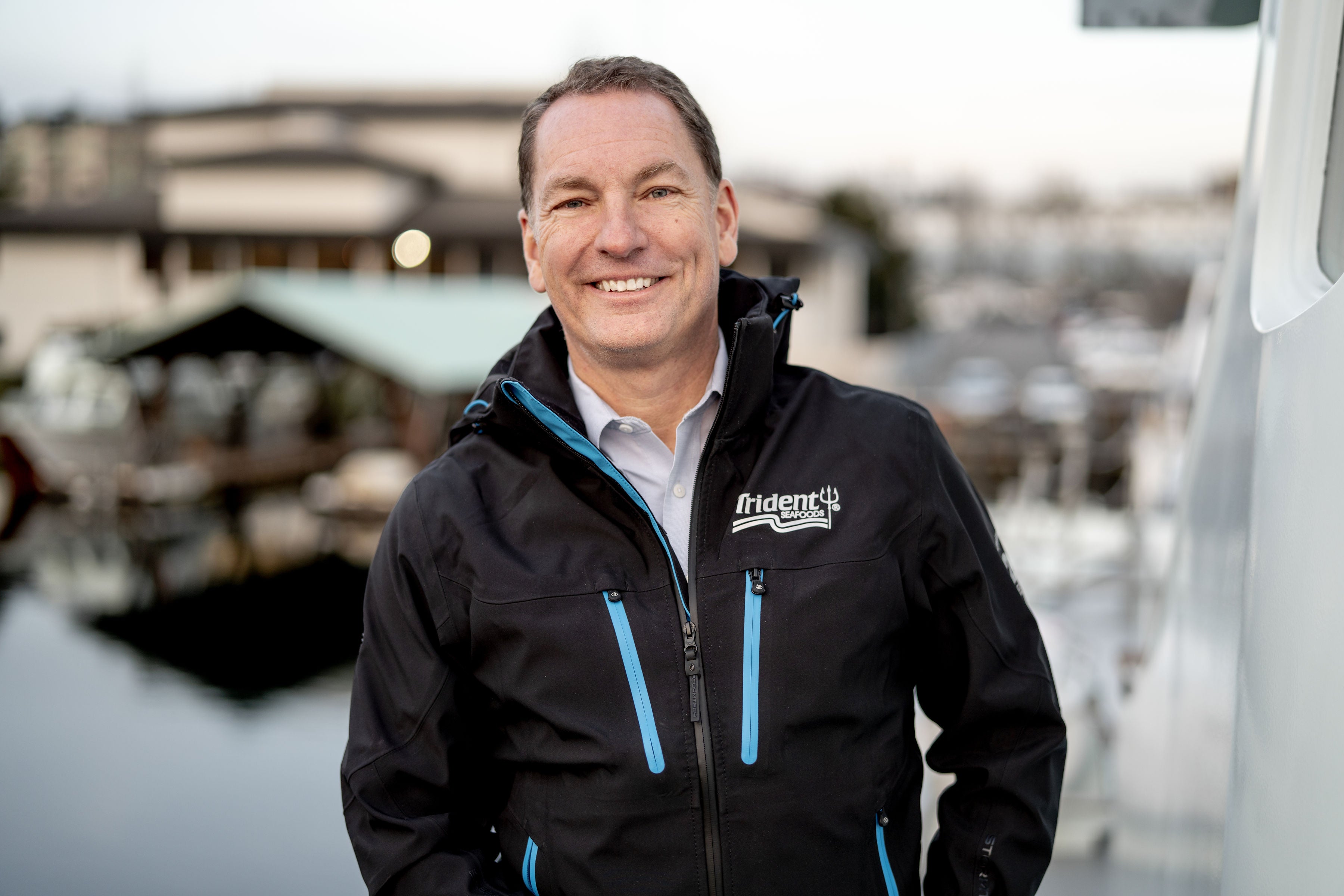 Joe Bundrant standing on deck of boat smiling