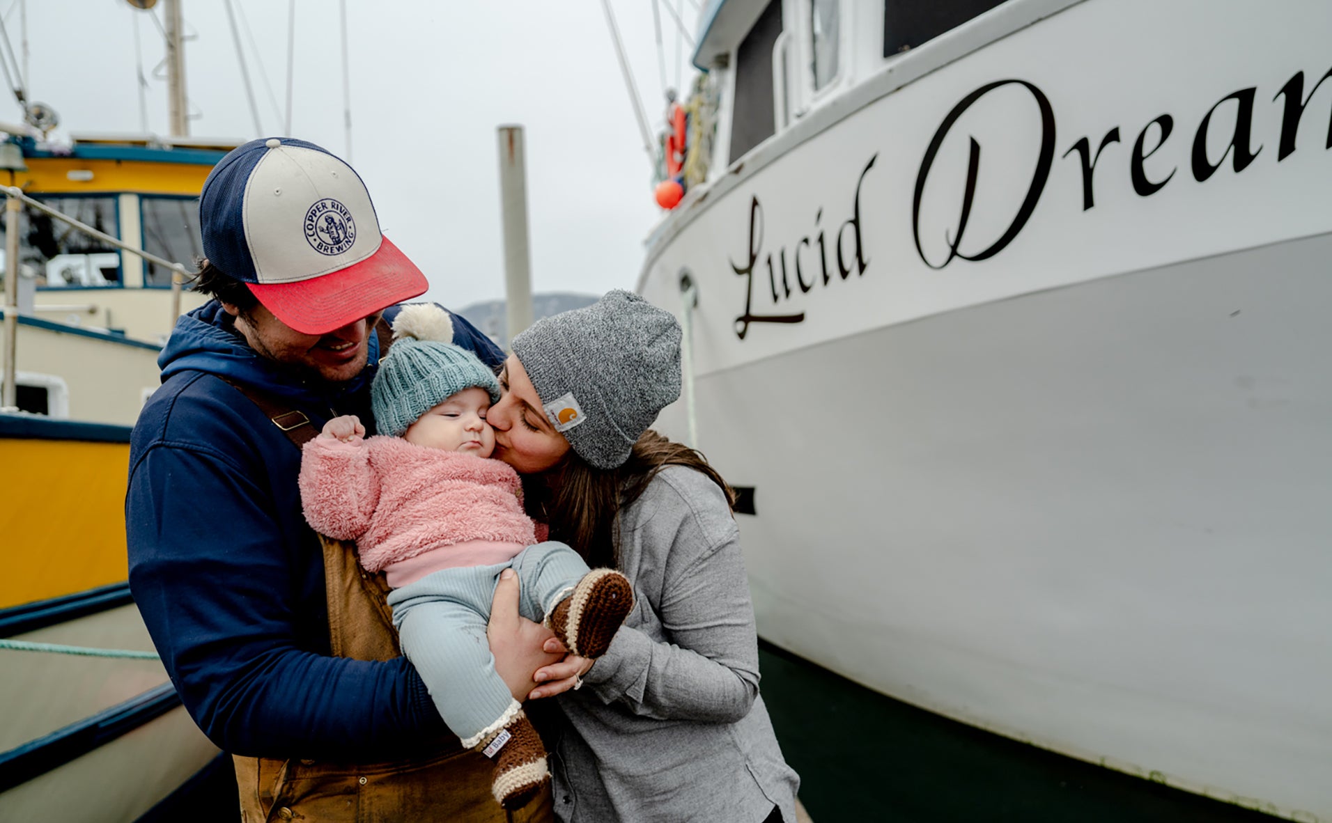 e, Kinsey and their daughter, Odette, in front of their fishing vessel Lucid Dream.
