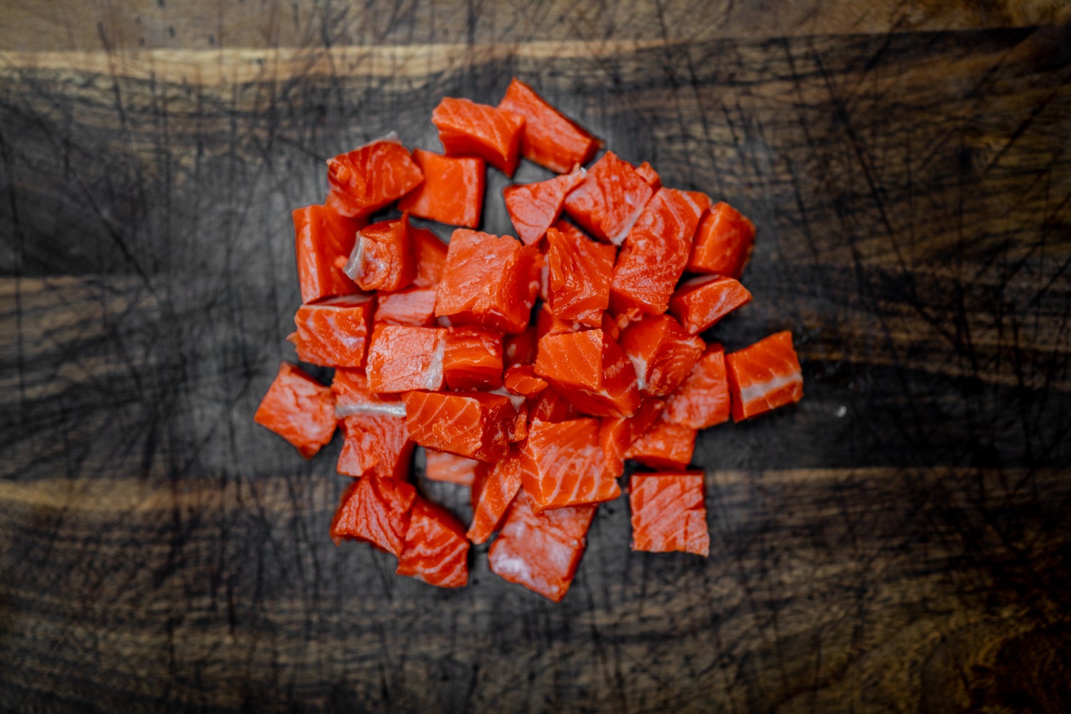 Wild Alaska salmon sits atop a bed of rice in this salmon and sweet potato bowl slide 3