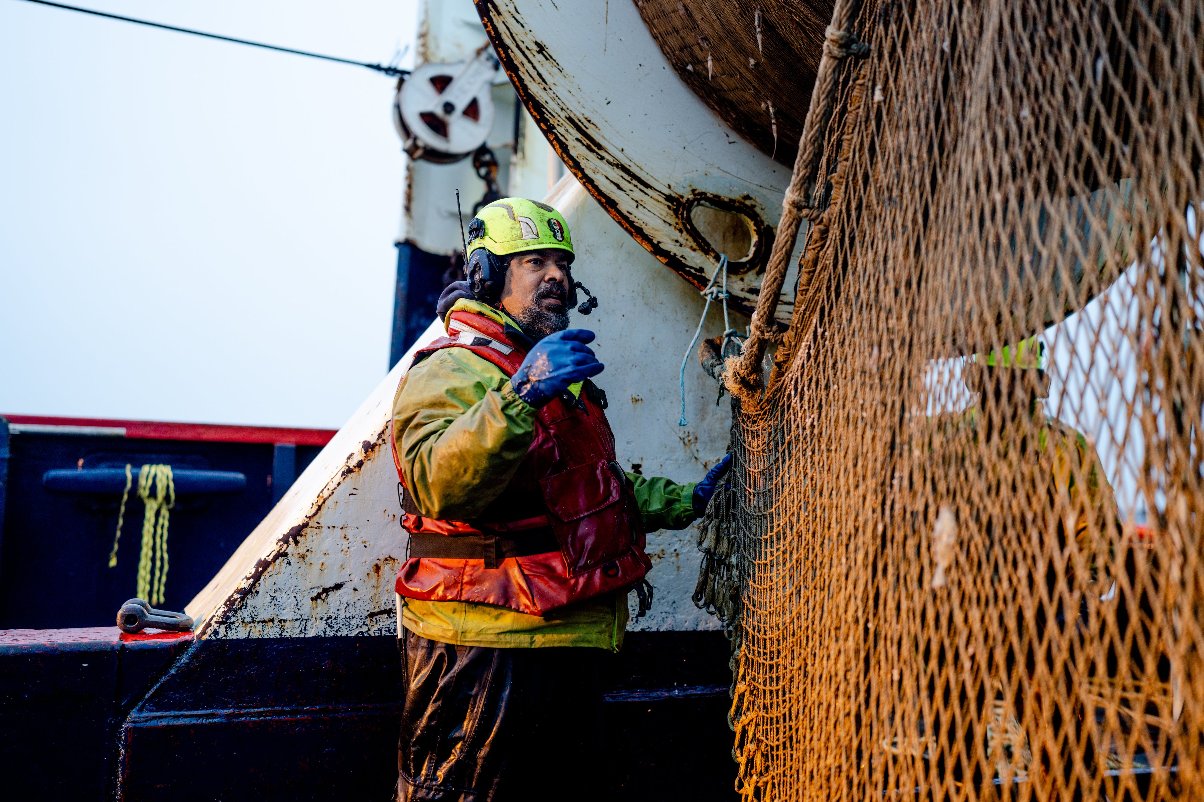 Aaron Willis, first mate aboard the Northern Patriot, checks the trawl net. 