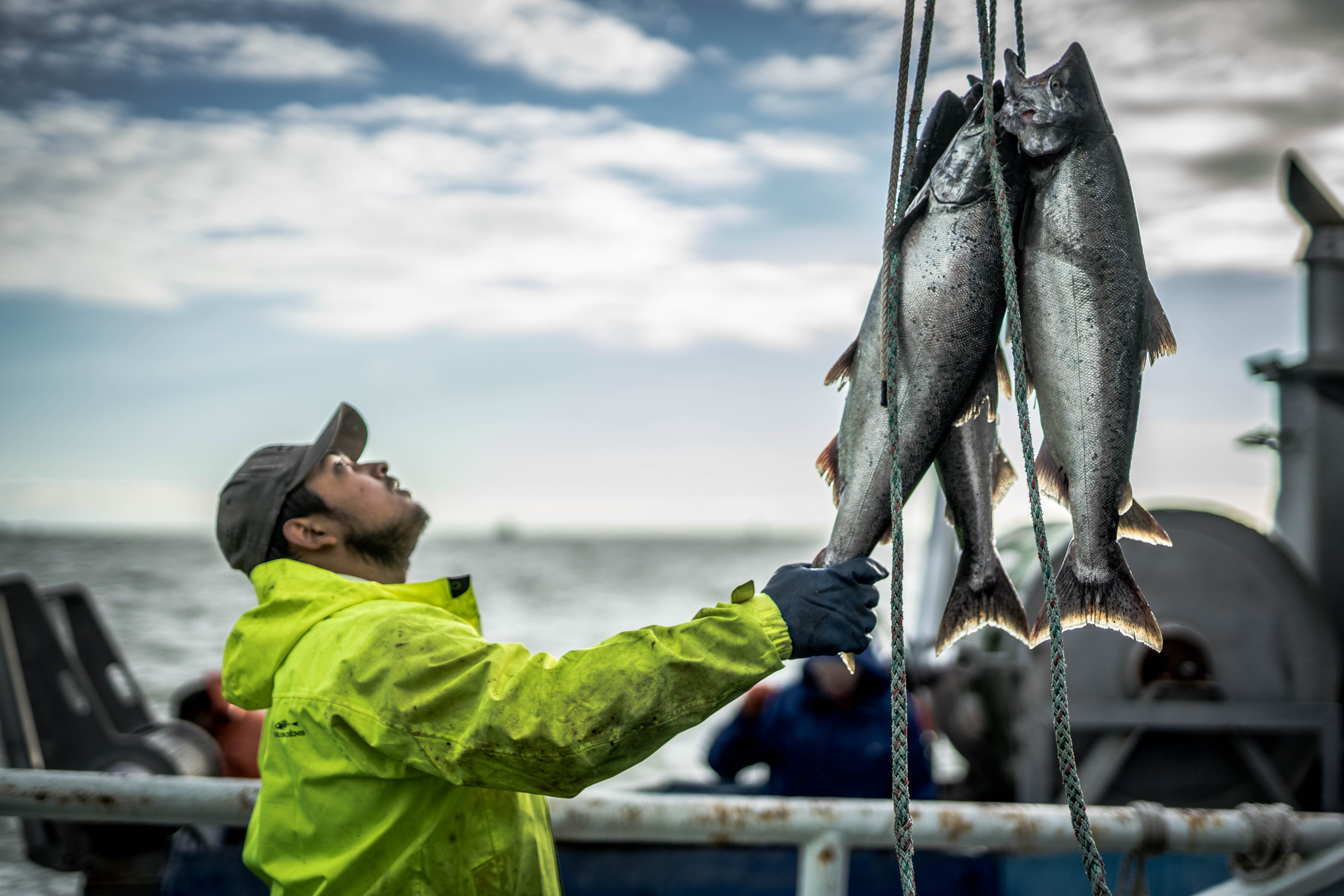 Fishermen working on deck of salmon boat in Alaska