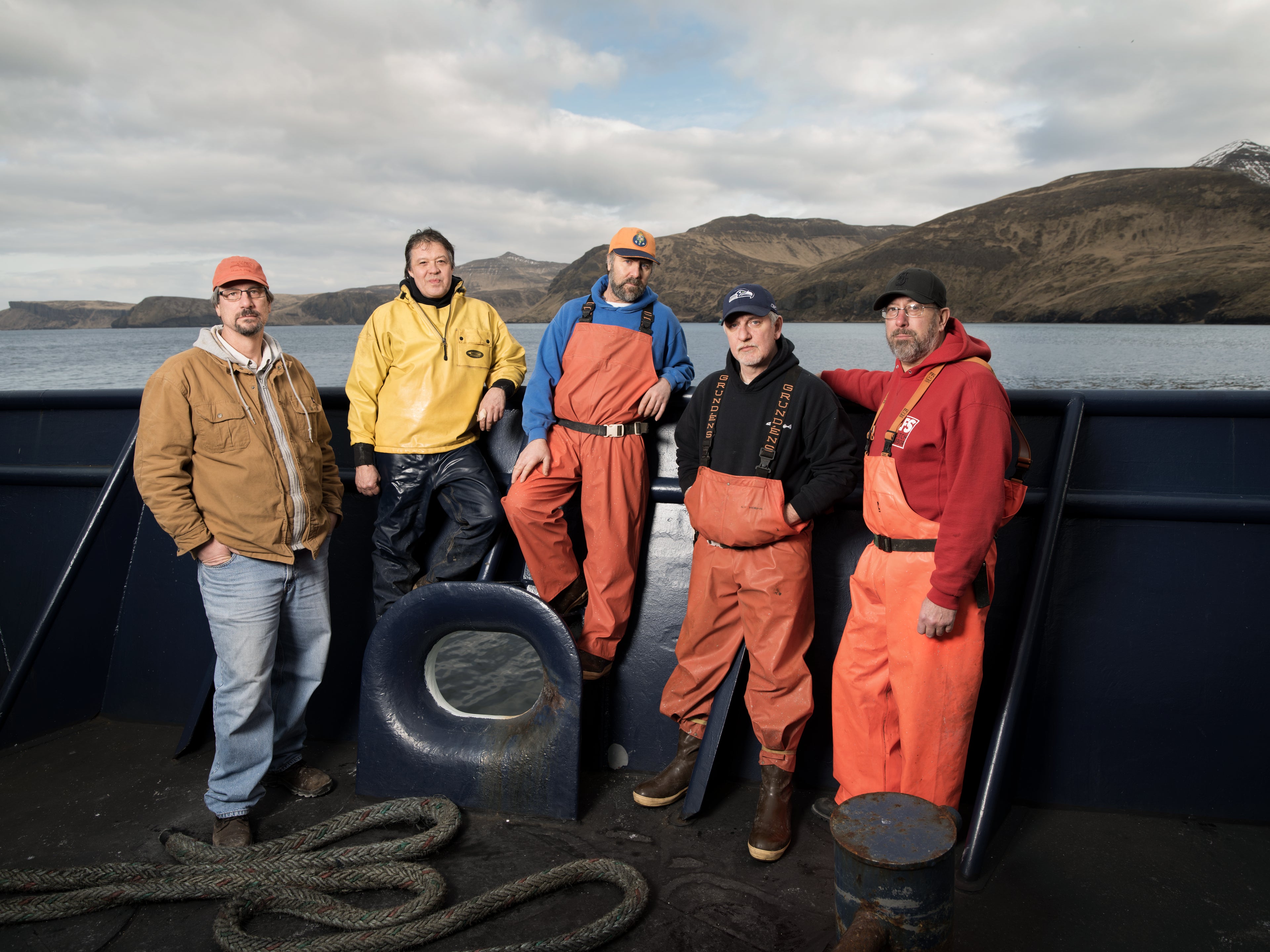Fishermen standing on deck of catcher boat in Alaska