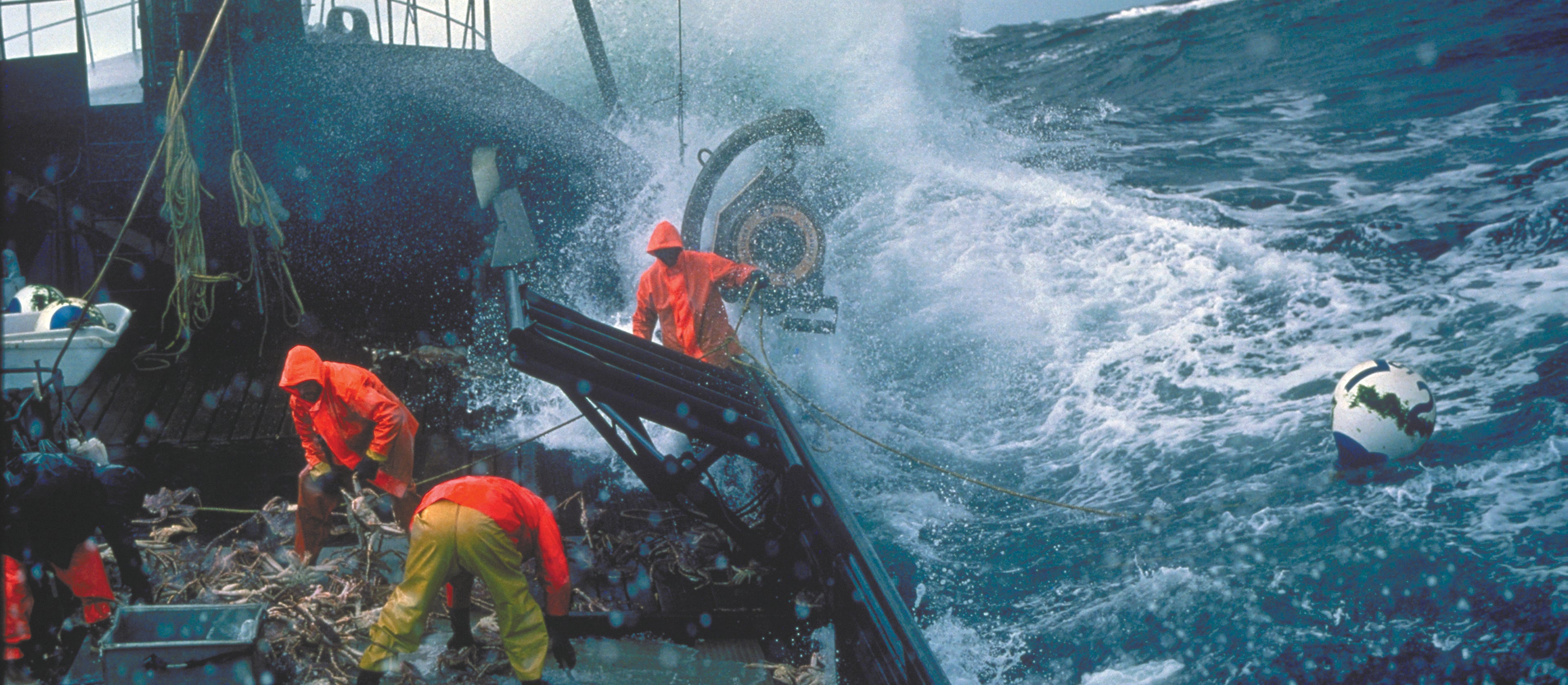 Crab fisherman working on deck in a storm