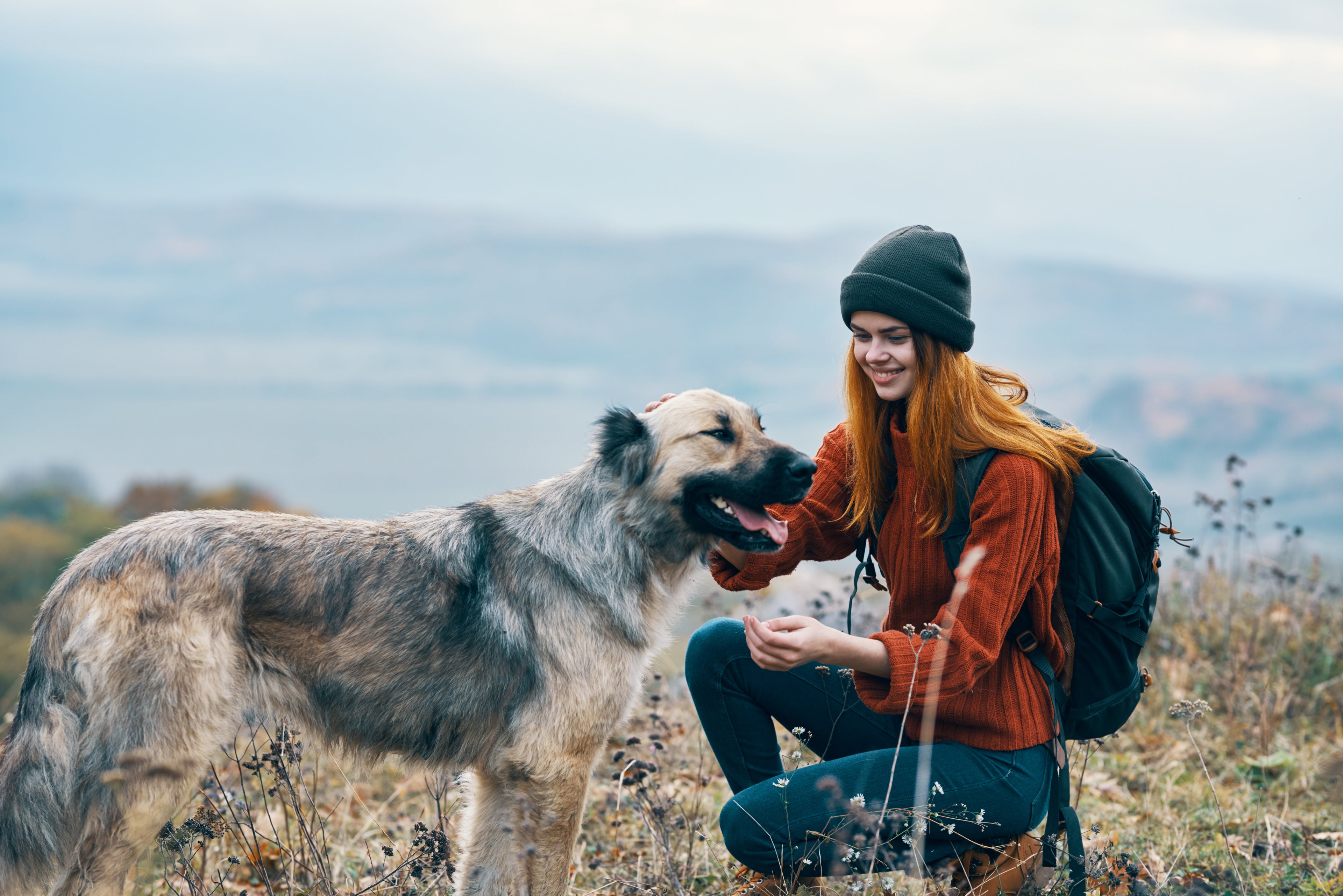 Woman petting her dog in the outdoors