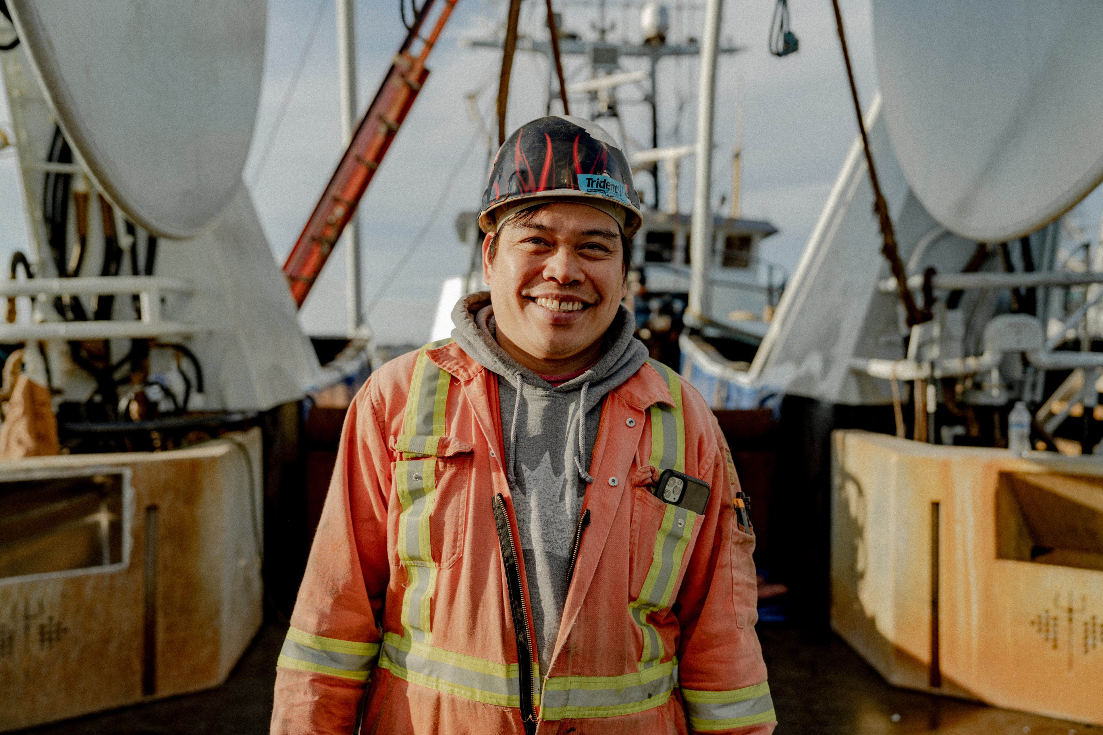 Worker standing on deck of catcher boat in Alaska