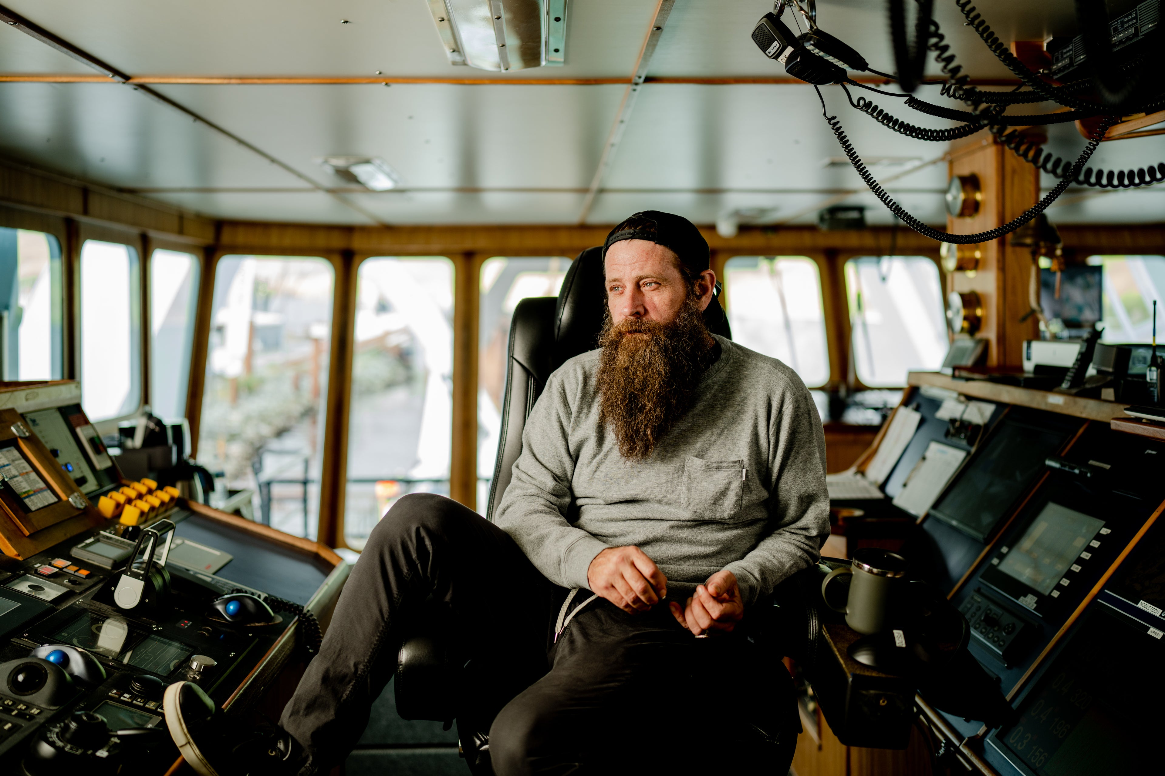 A crew member of CP Starbound sits in the vessel's wheelhouse