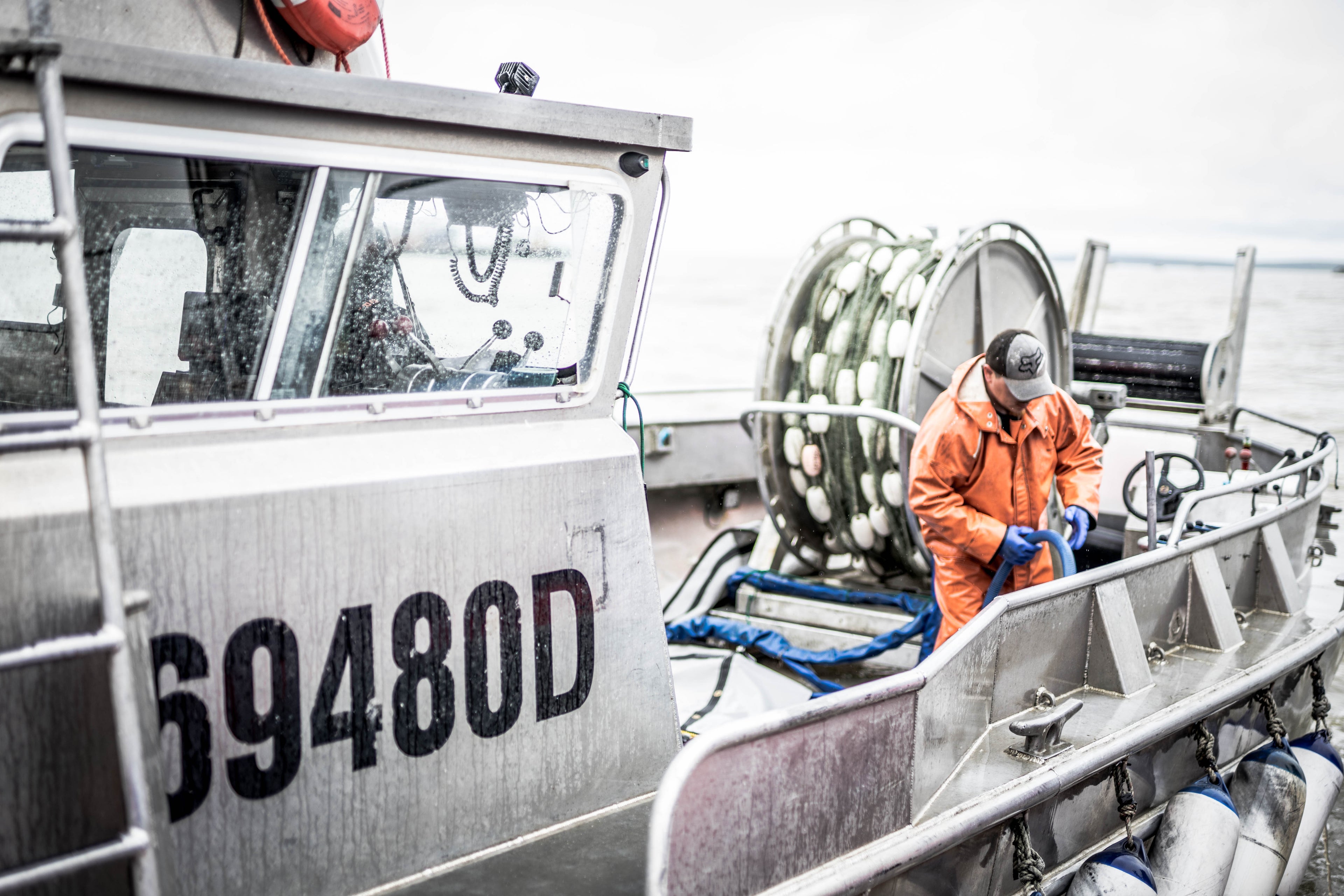 Man working on Bristol Bay gillnetter fishing boat