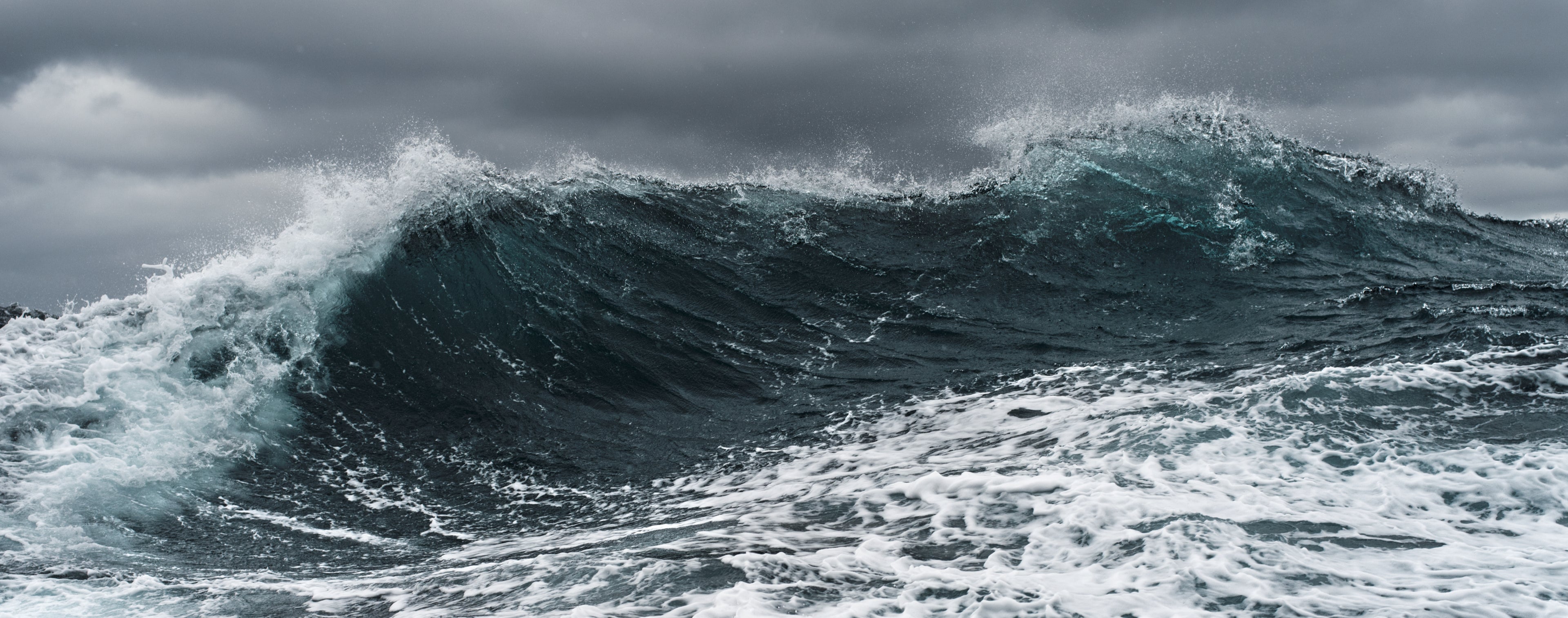 Waves folding over in a dark and stormy sea