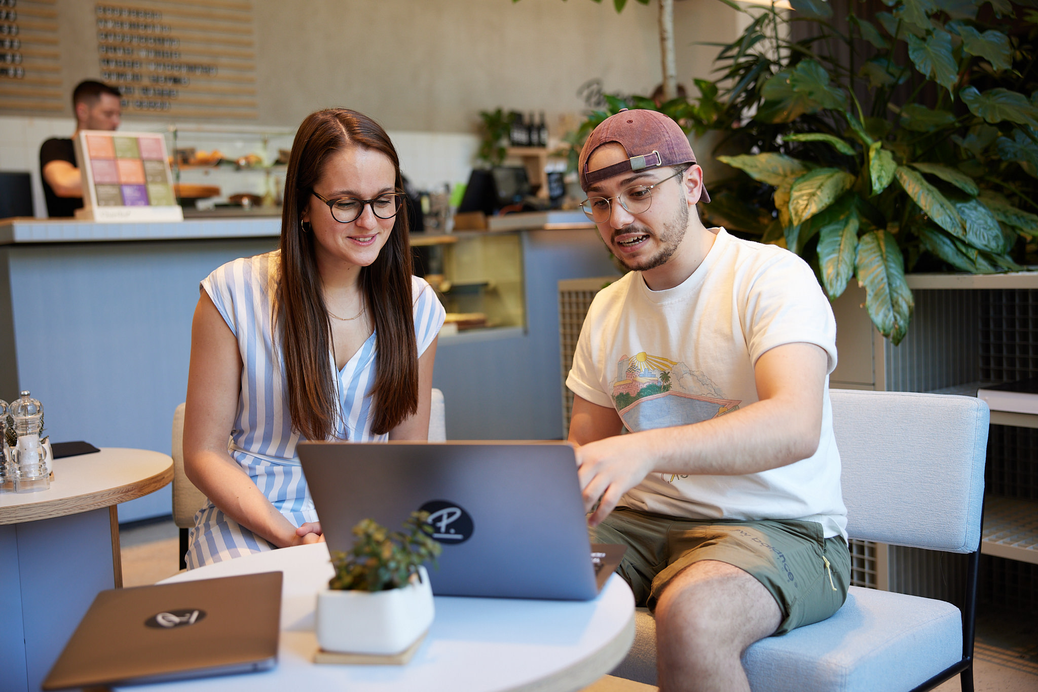 Two people looking at the laptop 