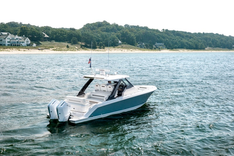 34 foot boat, 34 foot yacht, 34 LS at idle, view of starboard side, Hull Color: Fountain Blue, Tiara Yachts