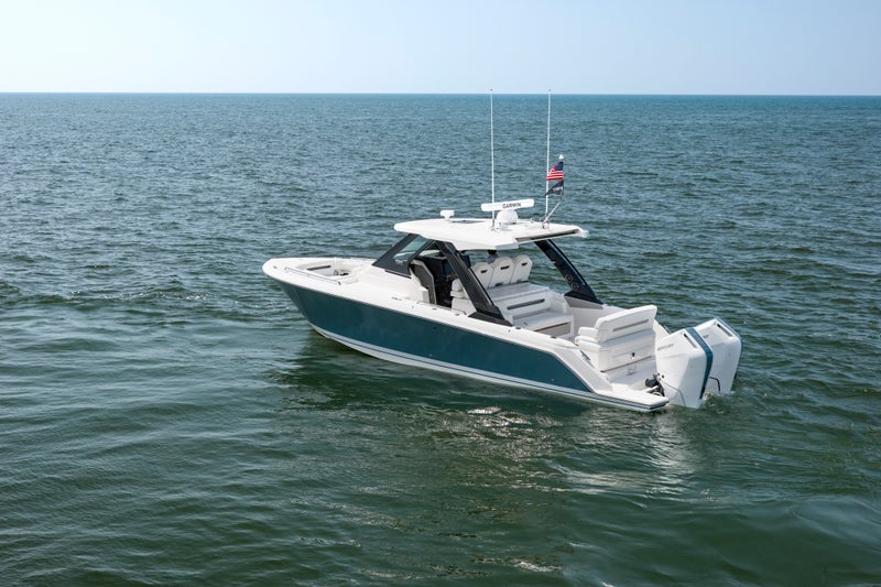 34 LS at idle, view of port side, Hull Color: Fountain Blue