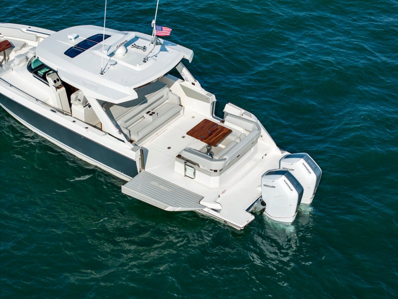 Tiara Yachts 43 LS with portside terrace deployed and starboard side boarding door ajar