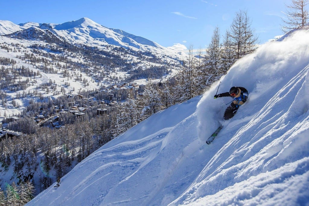 A skier glides down the slope at Vars ski resort