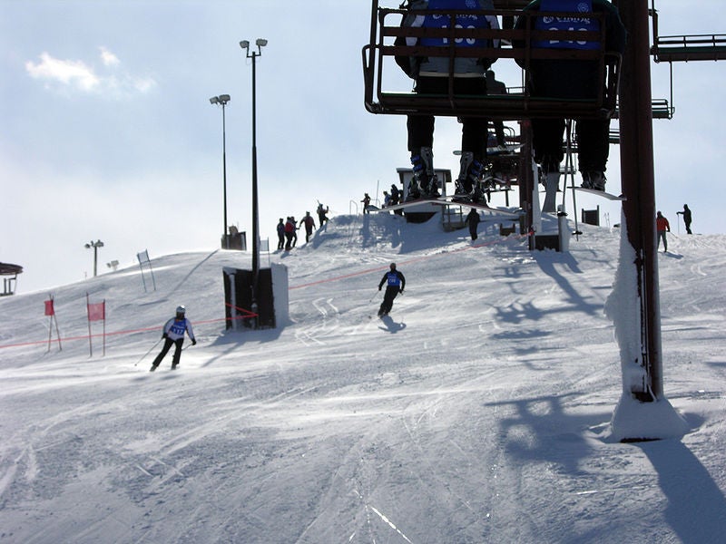 Skiers under the lifts of Wilmot Mtn, WI.