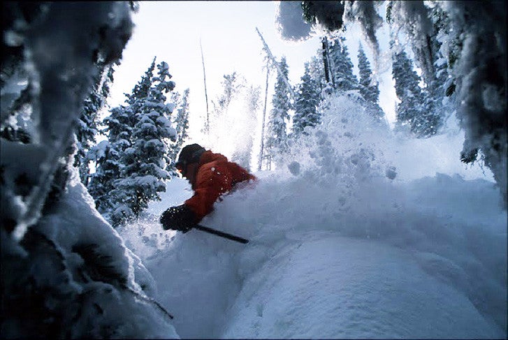 Skier crashing through powder at Lost Trail, Montana.