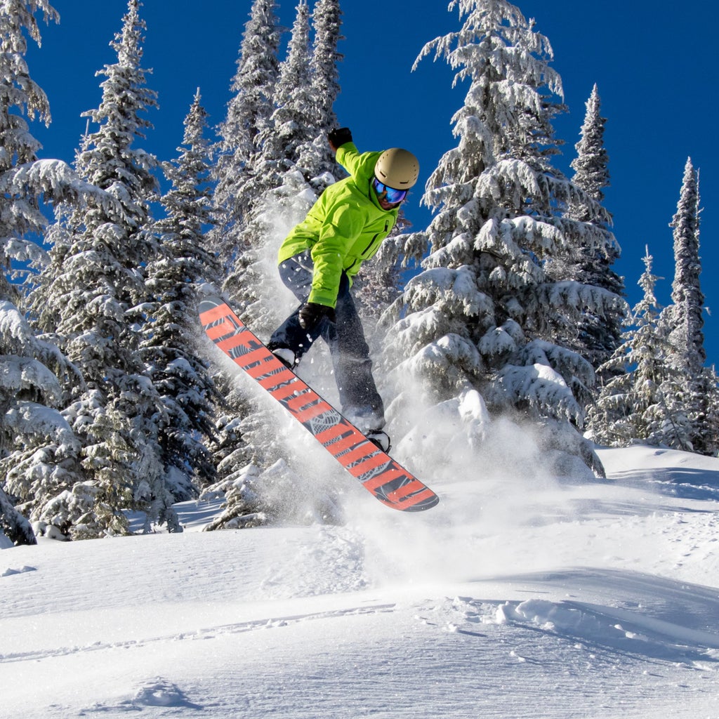 49 Degrees North Snowboarder Flying Powder