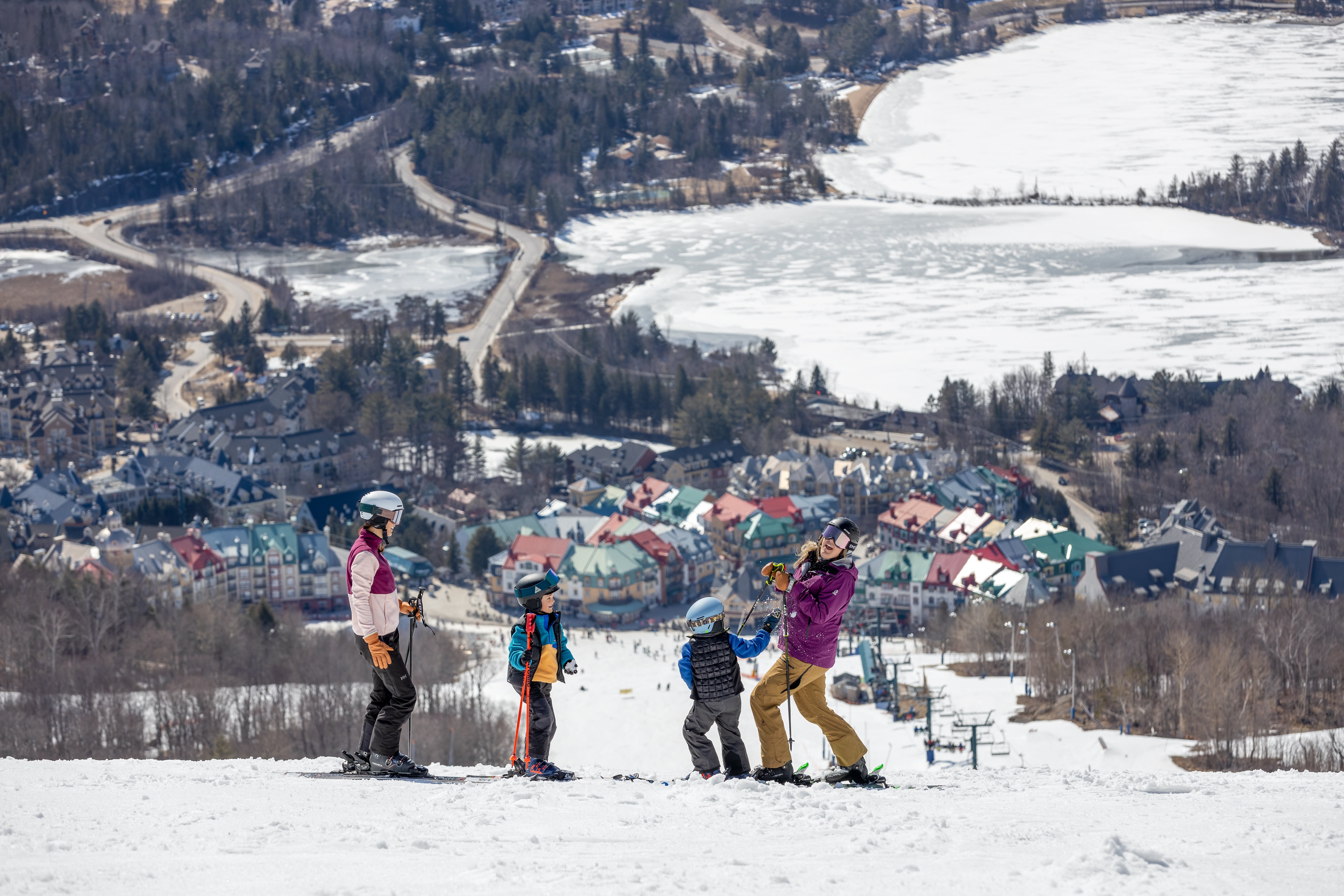 Family of skiers taking break on slopes at Tremblant Resort