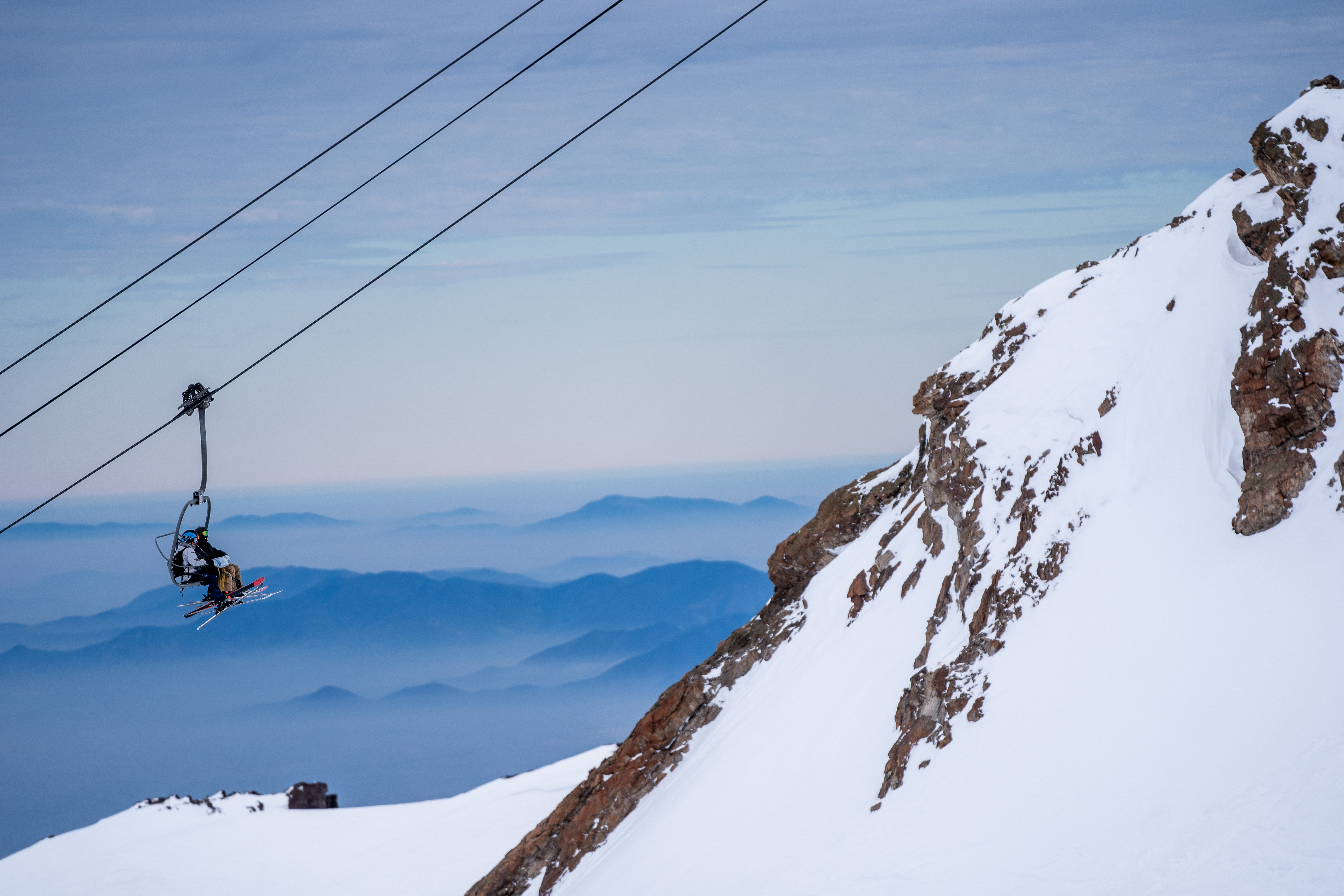 Skiers riding chairlift up Valle Nevado