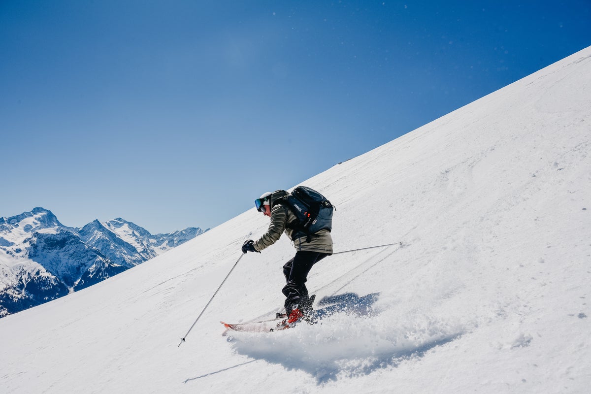 Carving down groomed slopes on a sunny day