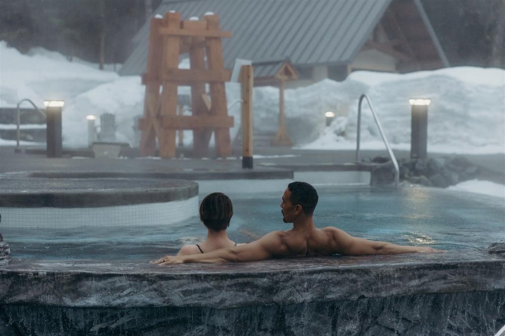 Couple enjoying a soak in pool at Alyeska Nordic Spa during the winter