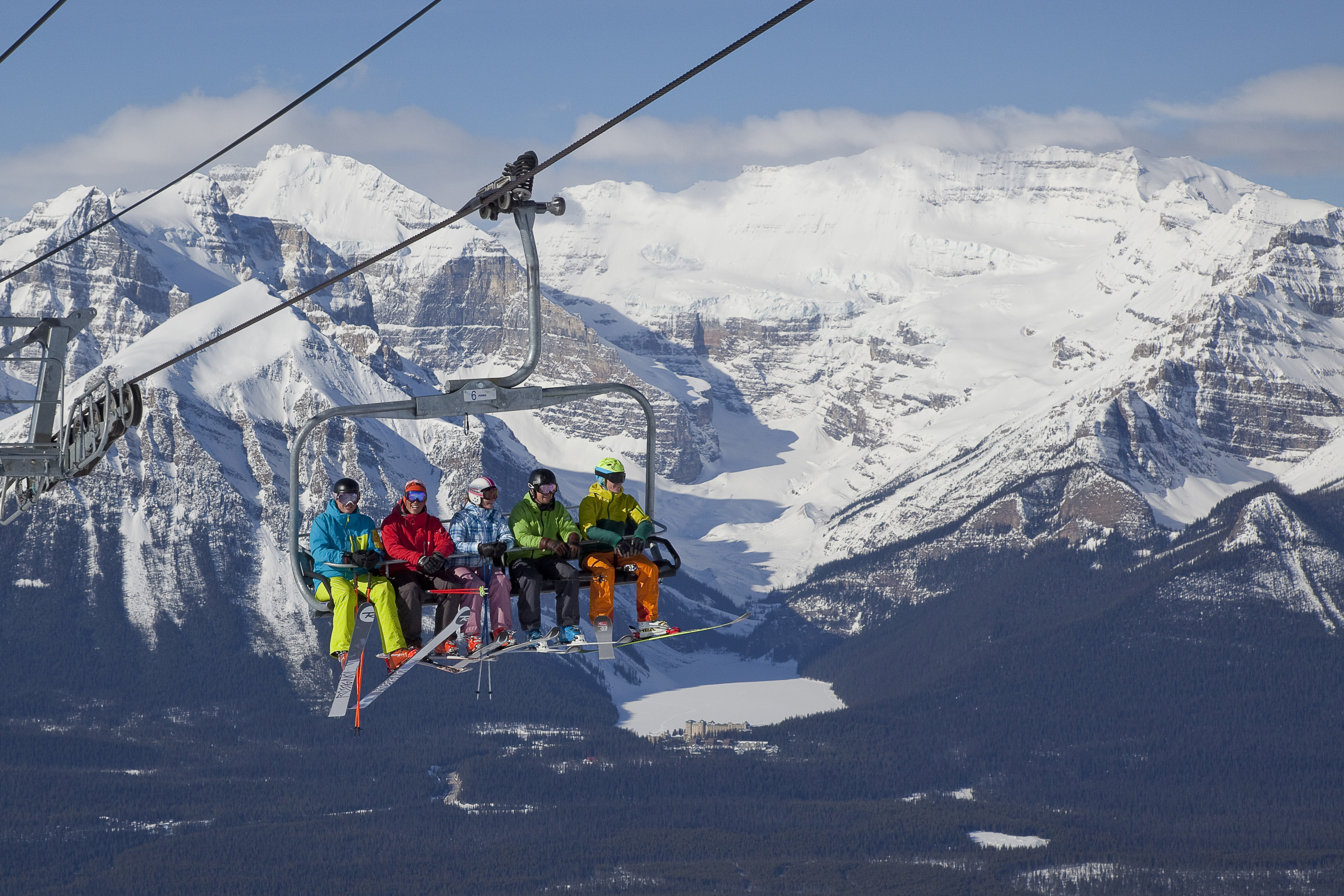 Skiers on lift in the Canadian Rockies at Lake Louise