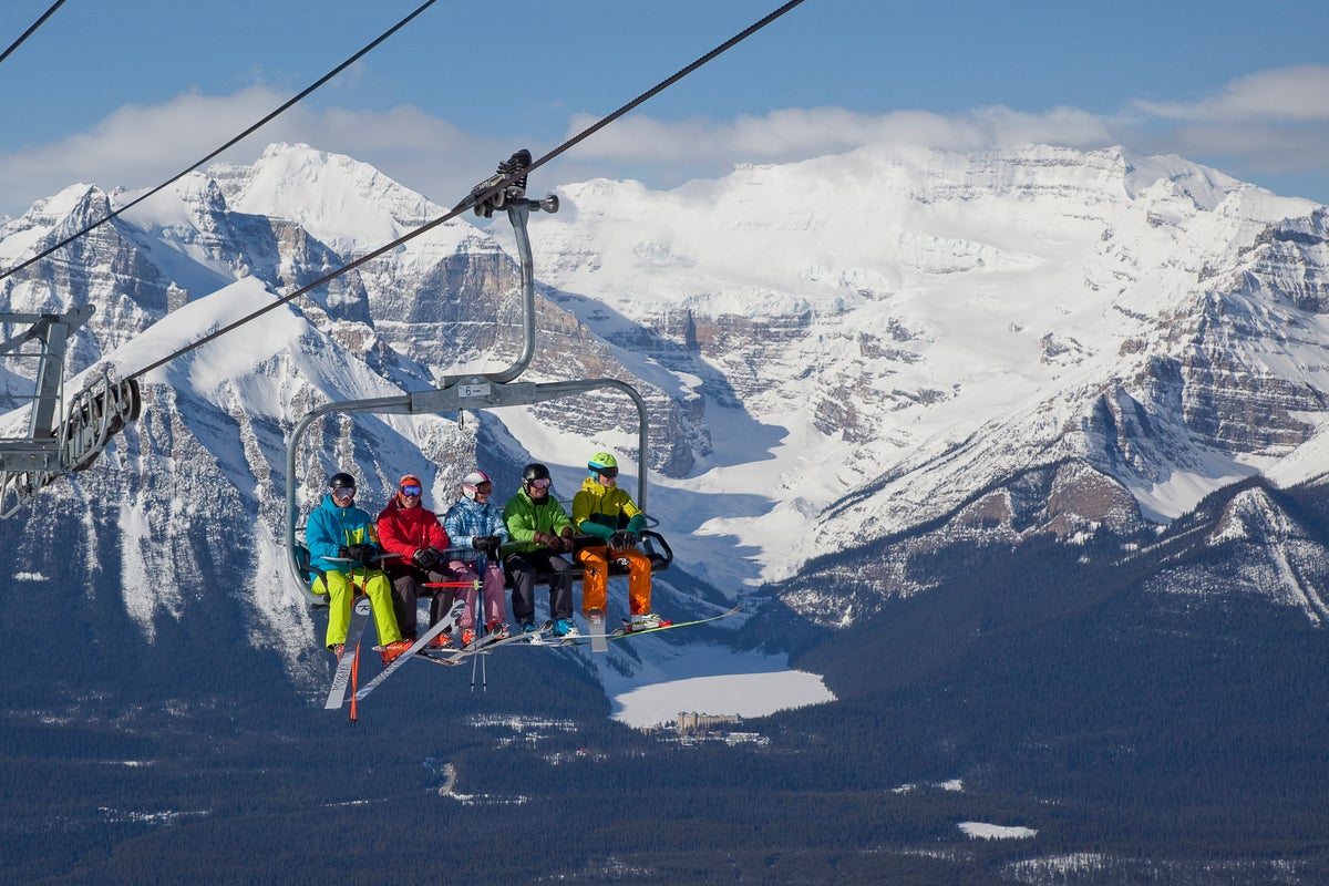 Skiers on lift in the Canadian Rockies at Lake Louise