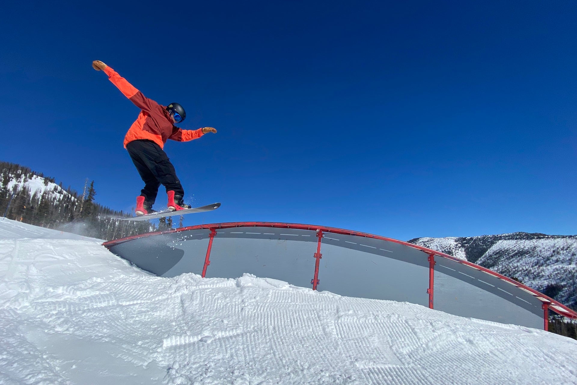 Snowboarder catching air on terrain park feature