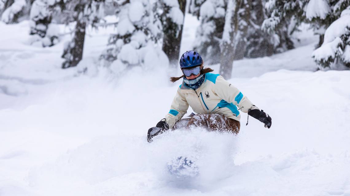 Person skiing through powder at Bluewood ski resort