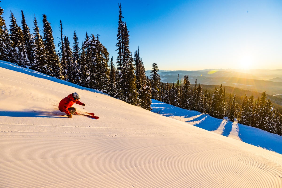 Ski Instructor Norman Kreutz skiing at Silver Star Resort on a bluebird day