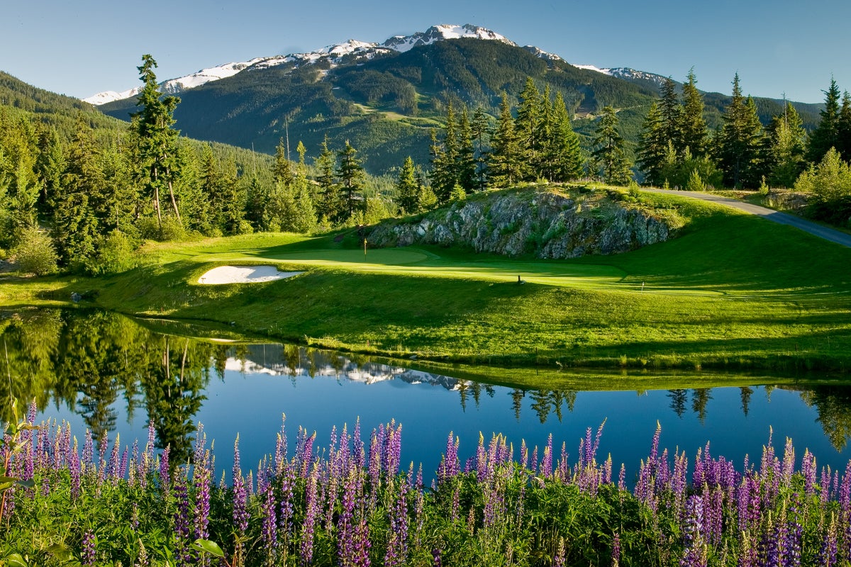Reflection off pond at Fairmont Chateau Whistler golf course on sunny day