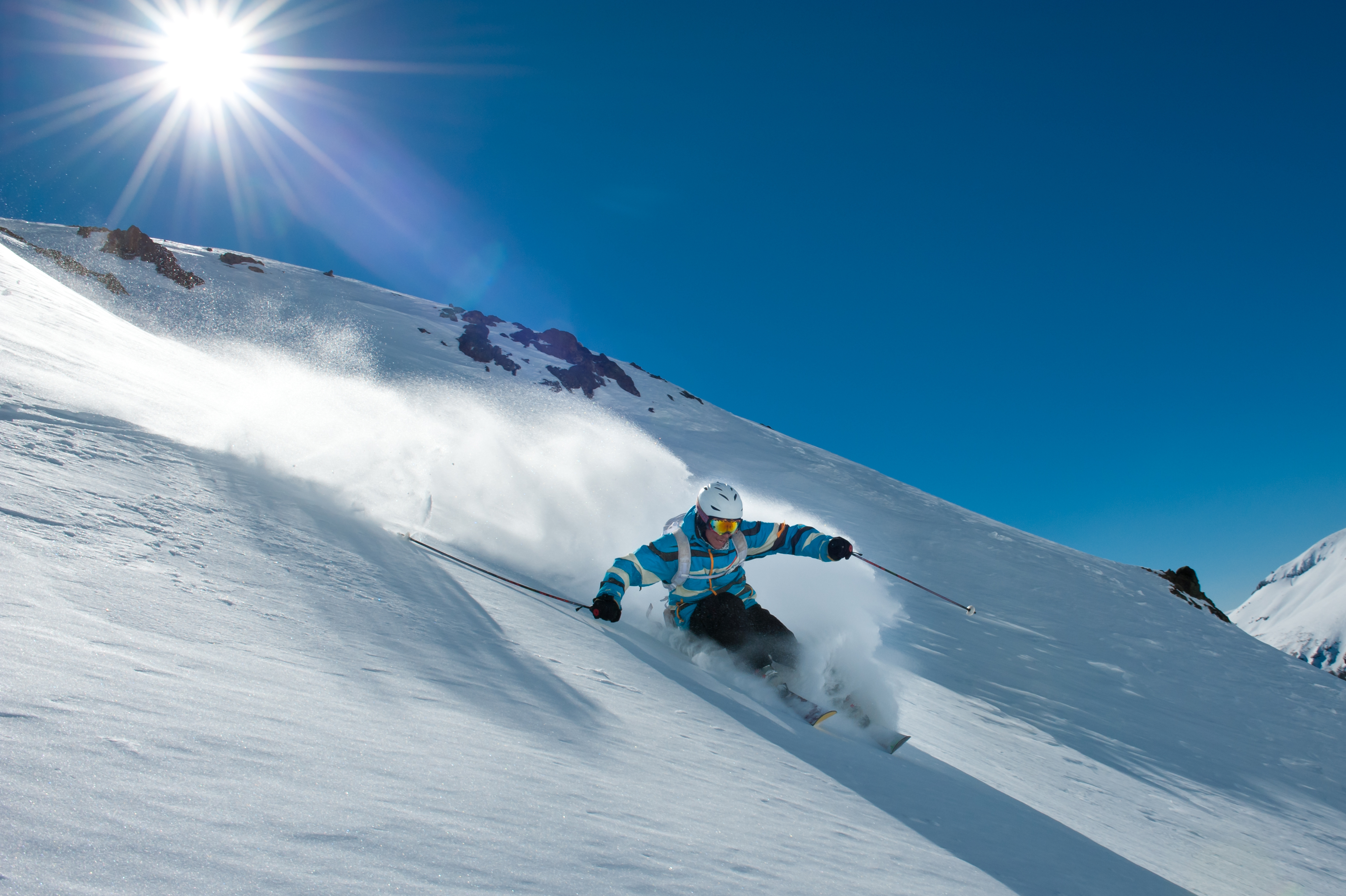 Skiing on a bluebird day through powder